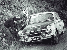 Don Barrow - The moment of truth - Jim Clark in his familiar crash hat pushing his car